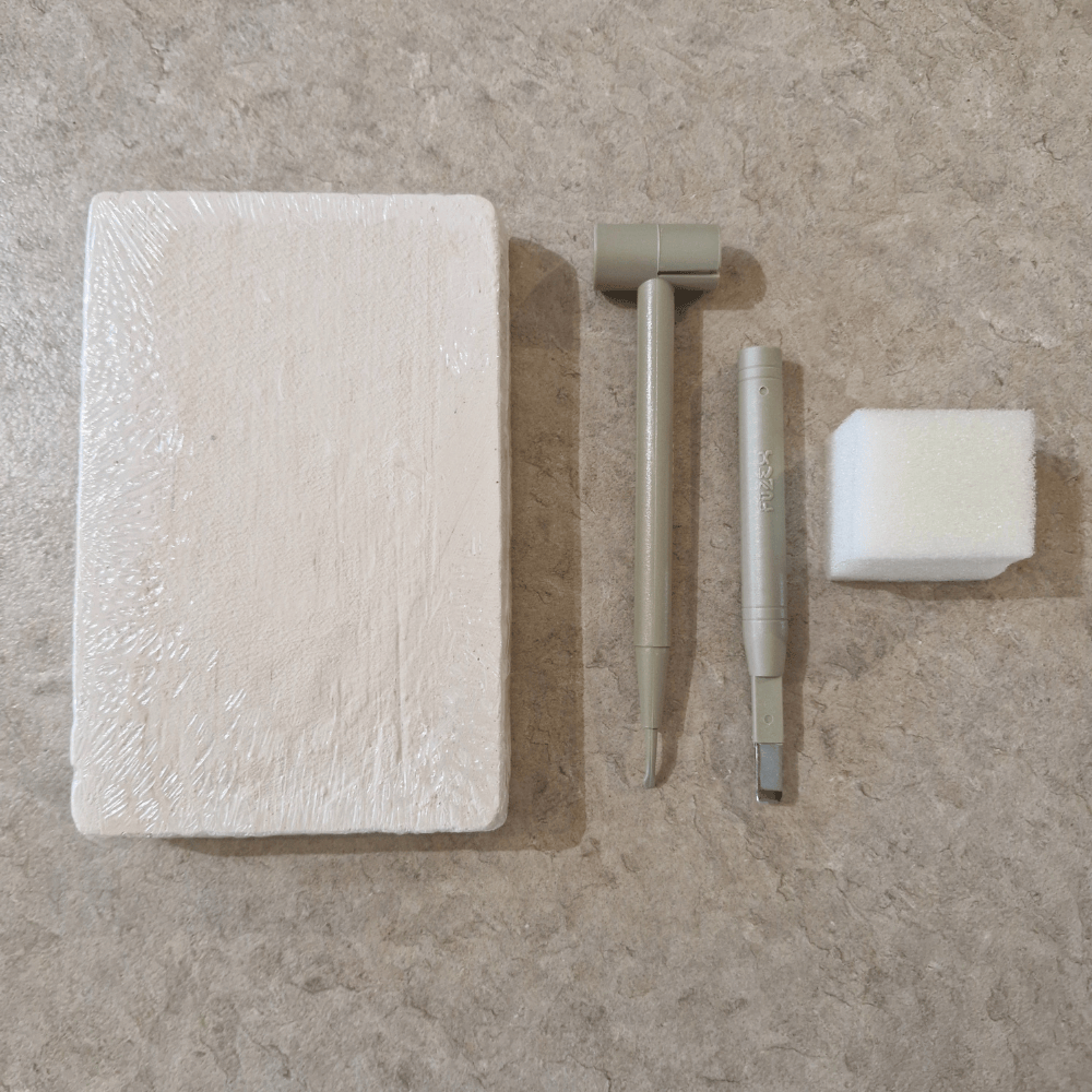 Plaster excavation block with chisel tools and sponge