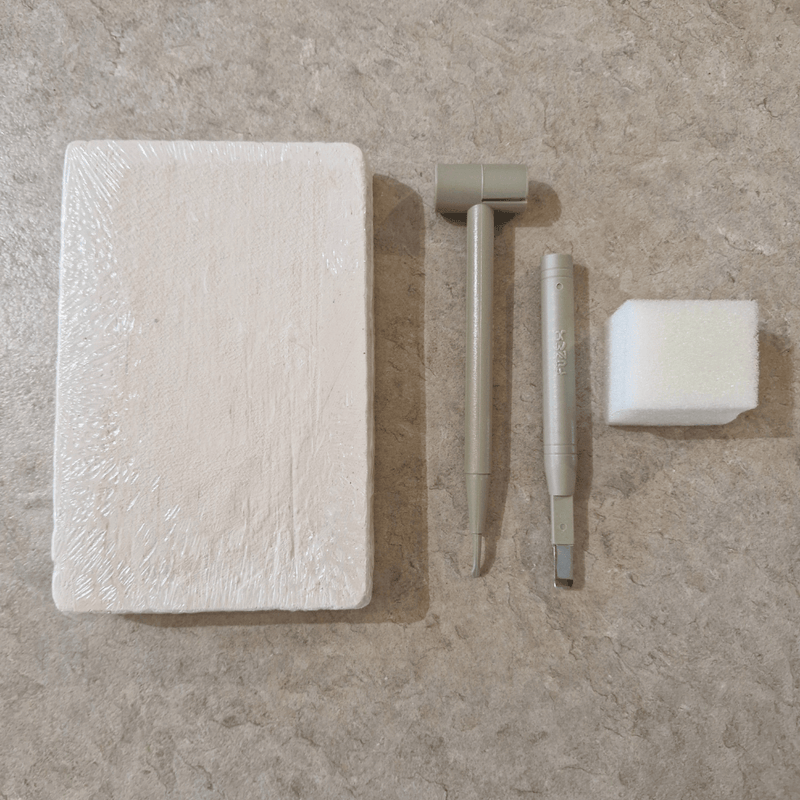 Plaster excavation block with chisel tools and sponge