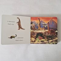 Children's book with dinosaur illustrations on a light gray background