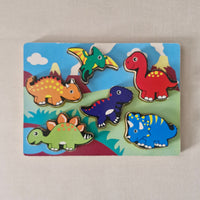 Colourful dinosaur-shaped wooden puzzle on a matching board.