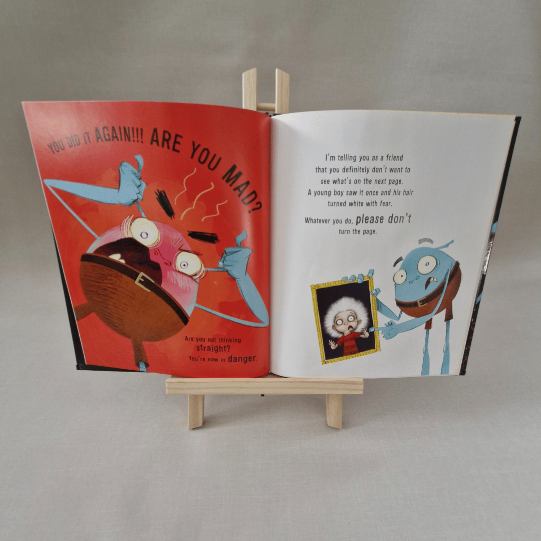 Open book with colorful illustrations on a grey background