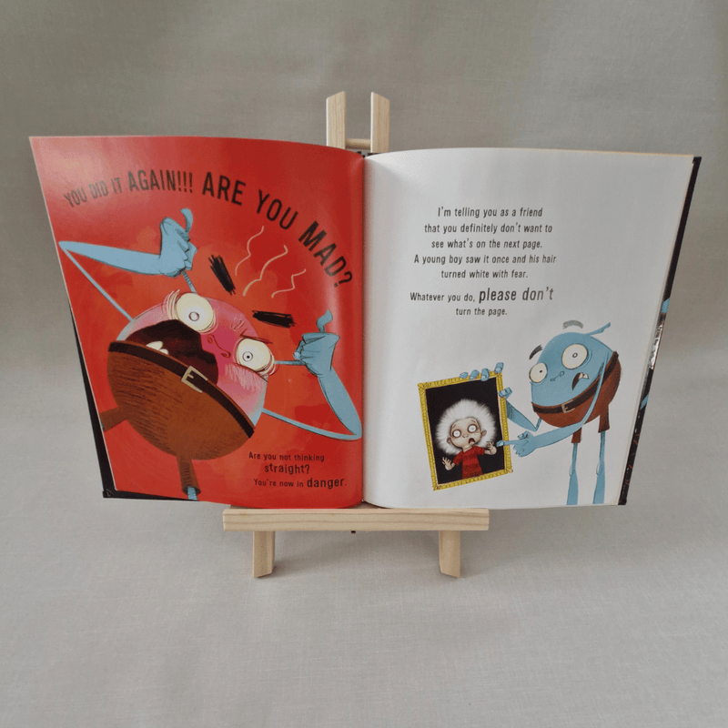 Open book with colorful illustrations on a grey background