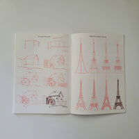 Open book with red line drawings on a white background