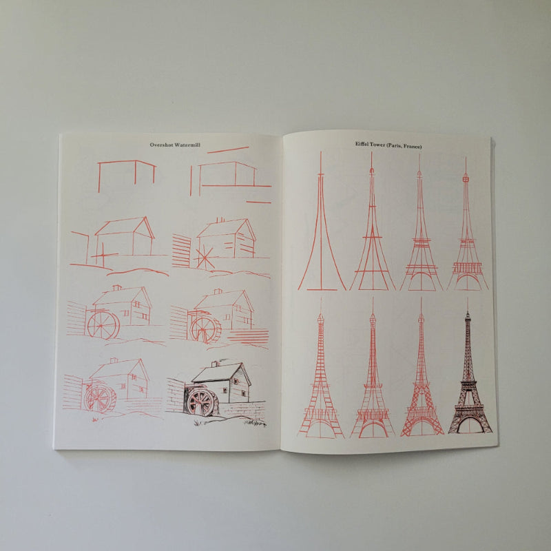 Open book with red line drawings on a white background