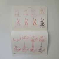 Open book with red line drawings of windmills on a white background