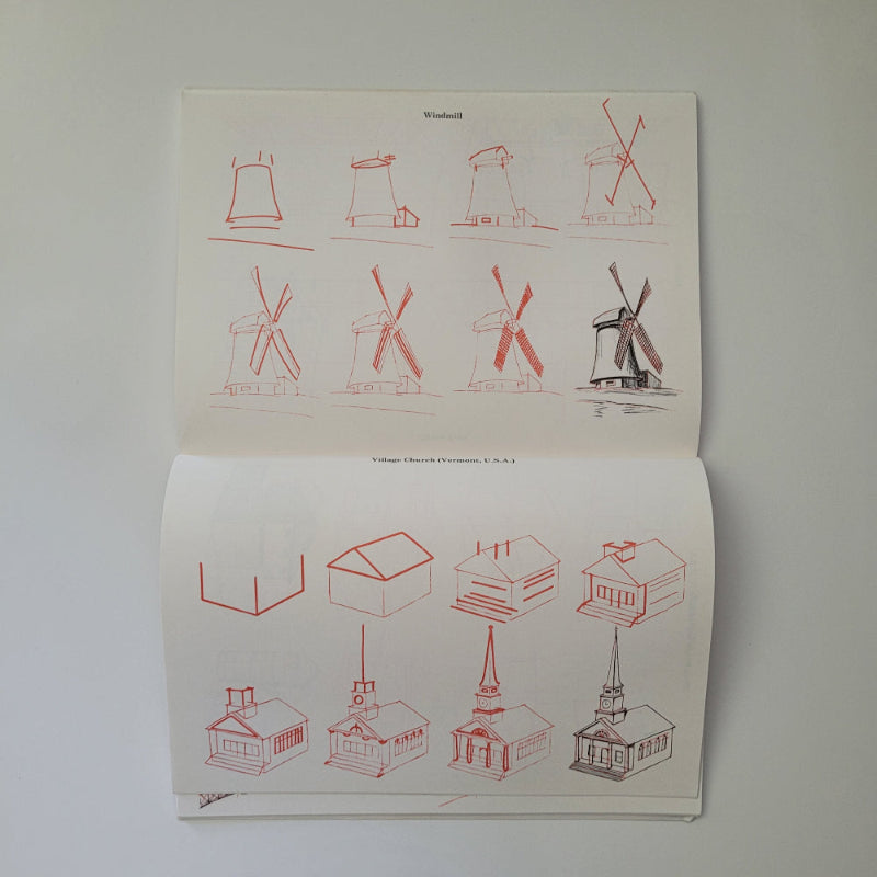 Open book with red line drawings of windmills on a white background