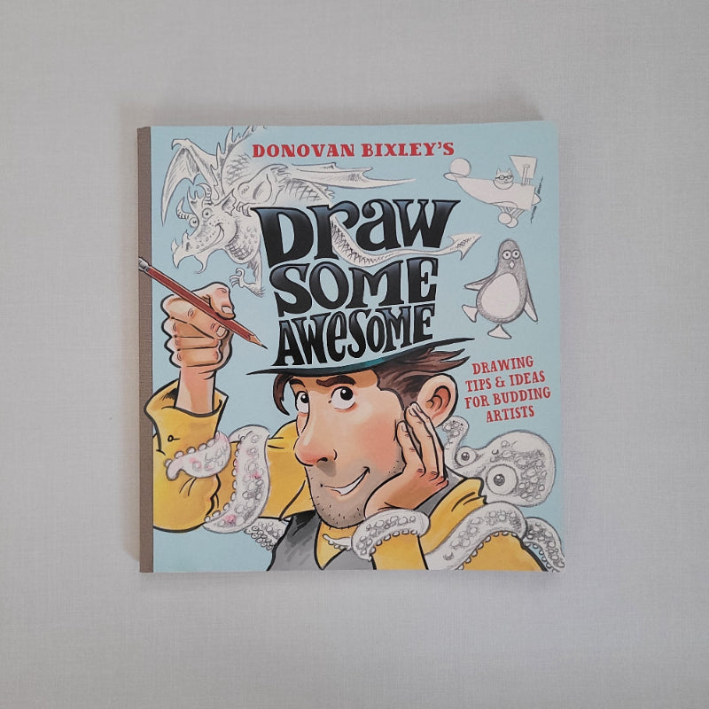 Book titled 'Draw Some Awesome' with a character holding a pencil on a light blue background.