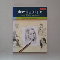 Book titled 'Drawing People' with illustrations on a gray background