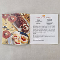 Cookbook with chocolate eclair recipe on a textured surface