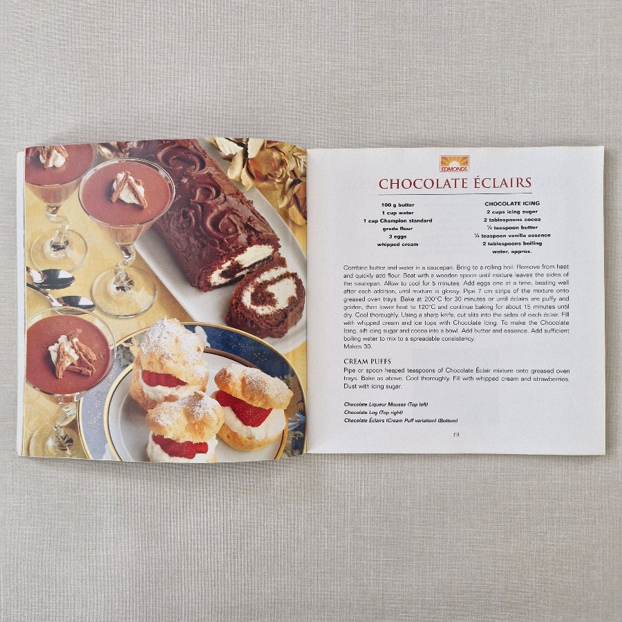 Cookbook with chocolate eclair recipe on a textured surface