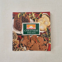 Edmonds Christmas Treats packaging with cookies and holly design on a textured surface