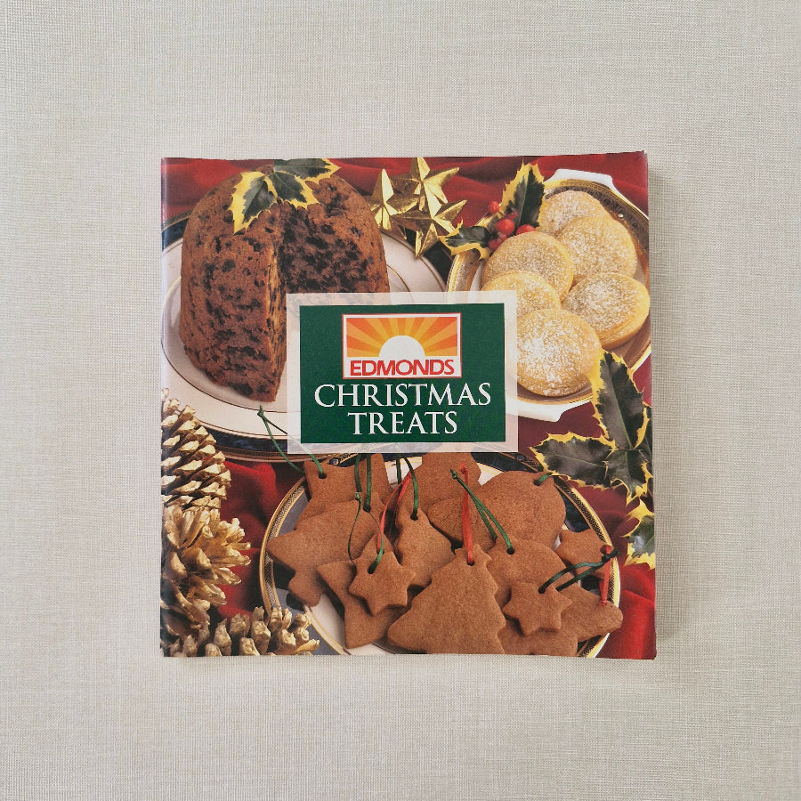 Edmonds Christmas Treats packaging with cookies and holly design on a textured surface