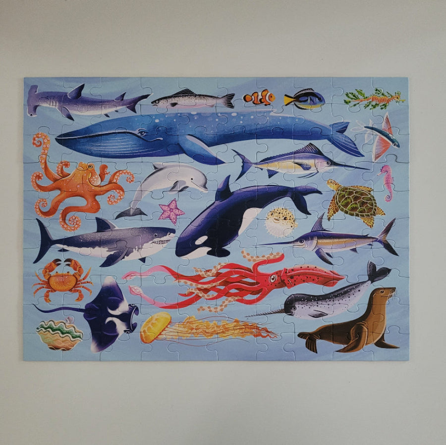 Jigsaw puzzle with various sea animals on a blue background