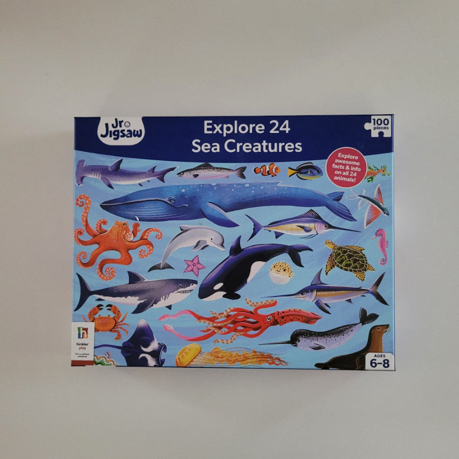 Jigsaw puzzle box featuring sea creatures on a blue background