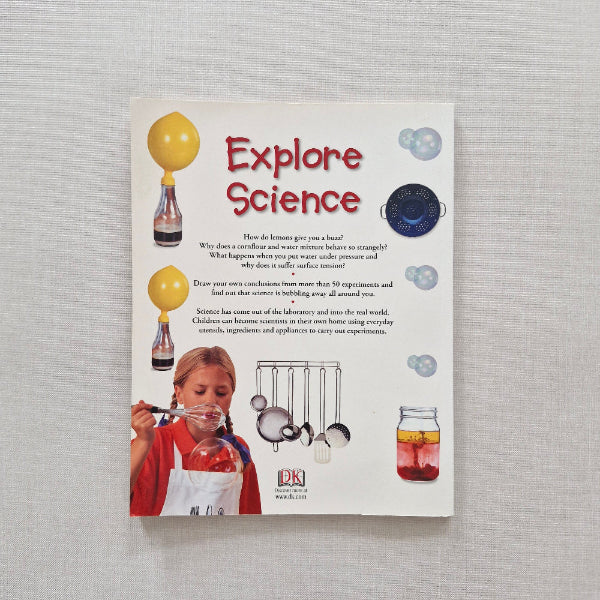 Book back cover with 'Explore Science' text and images of scientific equipment on a gray background