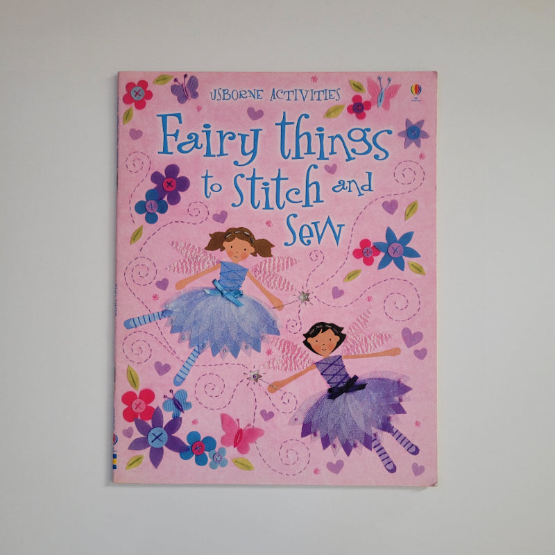 A front of a pink book with pictures of fairies, titled Fairy things to stitch and sew