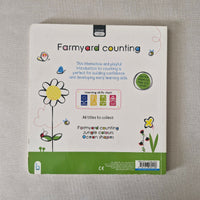 Back of a children's book with farmyard counting theme on a gray surface