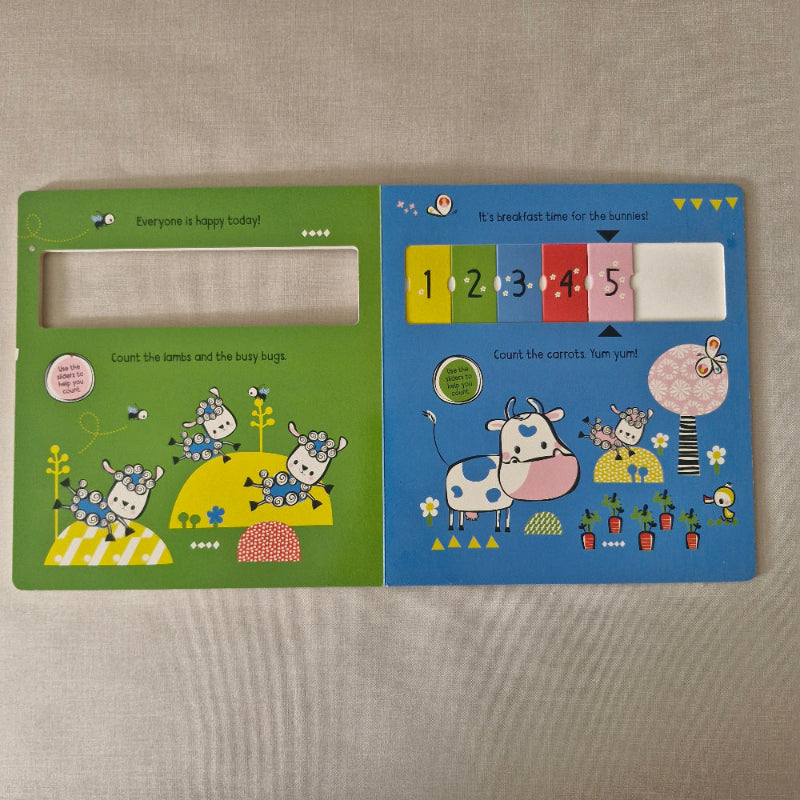 Open children's book with colourful illustrations on a textured surface