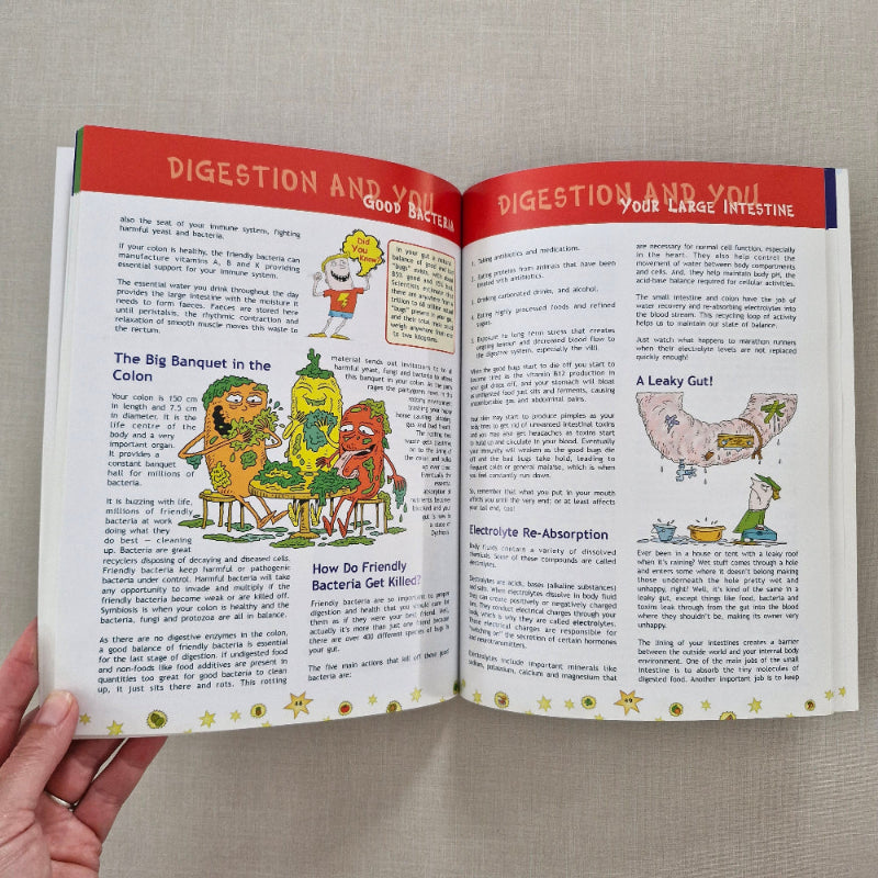 Open book with colourful illustrations on a beige surface