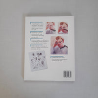Book cover with face illustrations and text on a gray background