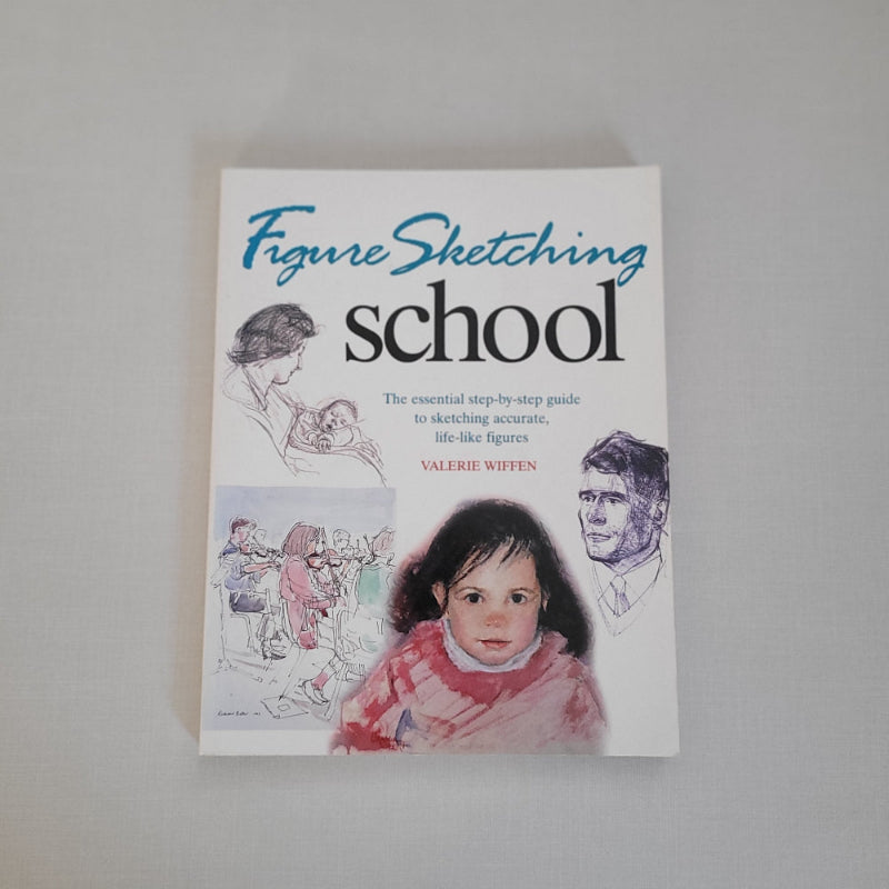 Book titled 'Figure Sketching School' on a plain background