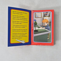 Open book with a colourful illustration on a grey background