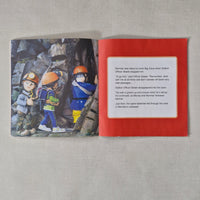 Open book with illustration of climbers and text on a red background