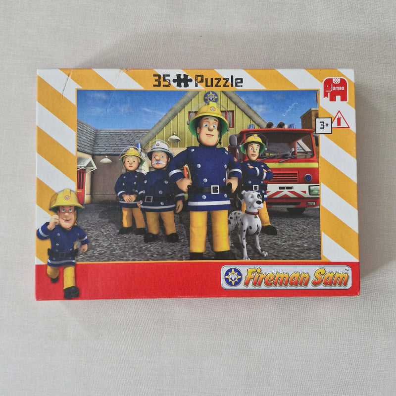 Fireman Sam puzzle box with characters and a fire engine on a light grey background