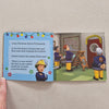 Children's book with illustrations of firefighters and Christmas decorations on a beige background