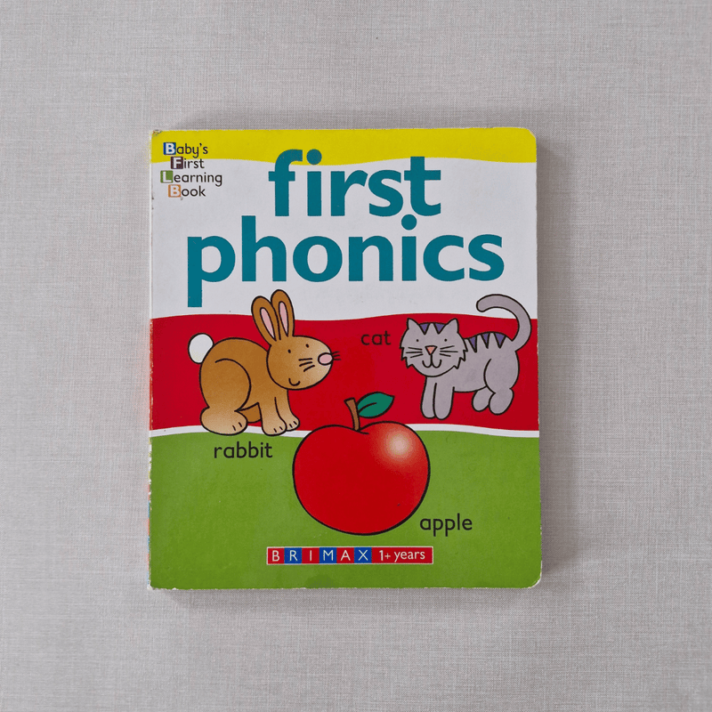 Children's book titled 'first phonics' with animal illustrations on a grey background
