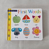 Children's book titled 'First Words' with illustrations and text on a grey background