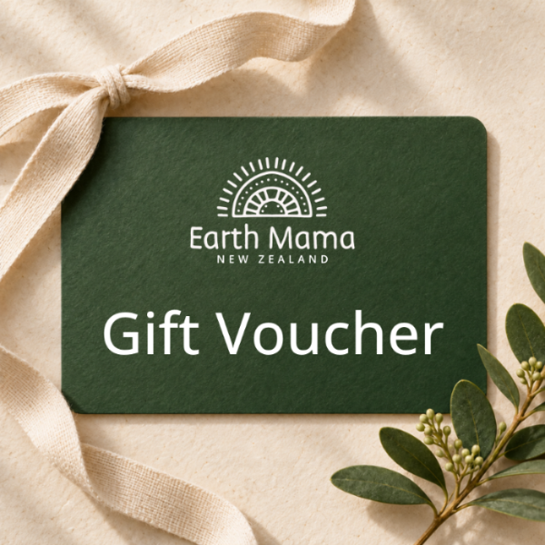 A dark green gift voucher card with white text reading 'Earth Mama New Zealand' and 'Gift Voucher,' styled on a beige fabric background with a cream ribbon and green leaves.