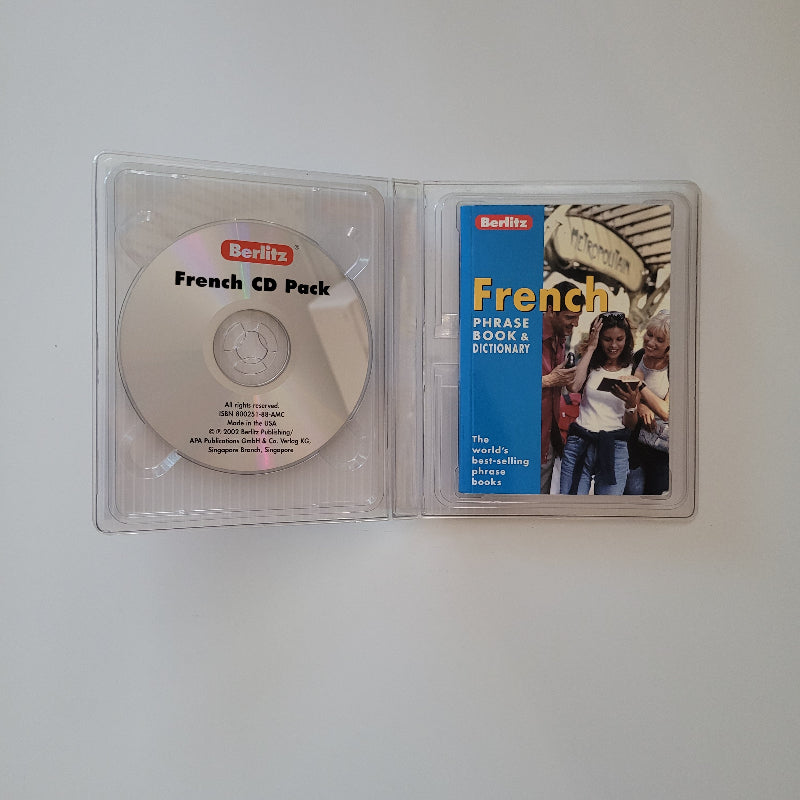 Open plastic case showing a CD and Phrase book for the French language