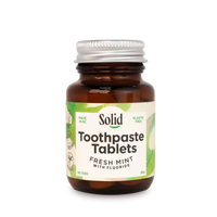 Bottle of Solid Toothpaste Tablets with a white background