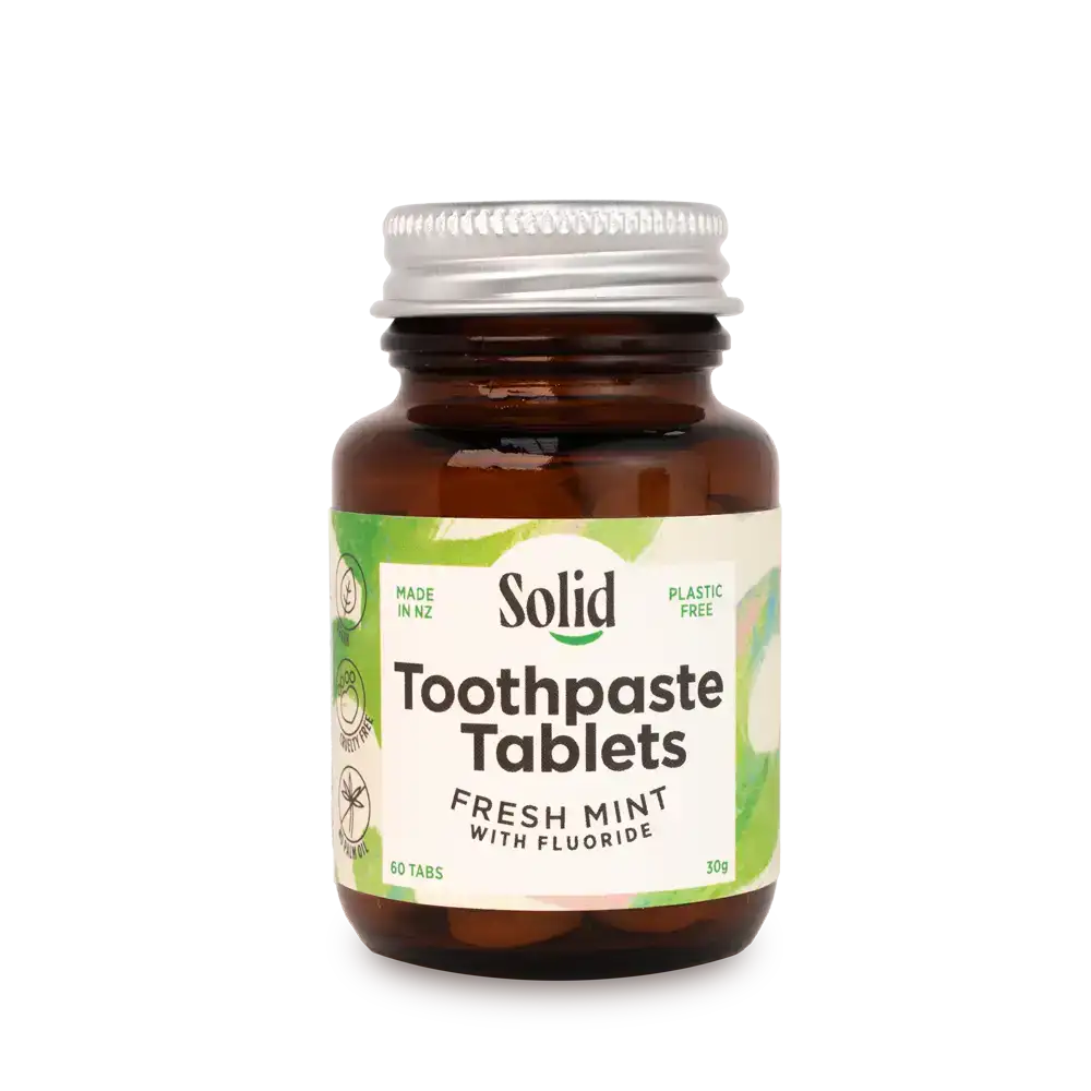 Bottle of Solid Toothpaste Tablets with a white background