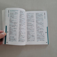 Open dictionary book with text on a plain background