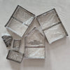 Gingerbread House metal cookie cutters wrapped in plastic on a grey surface