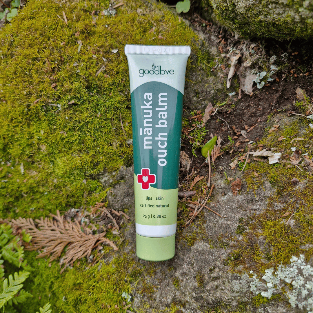 Manuka Ouch Balm tube on a natural background with moss and leaves