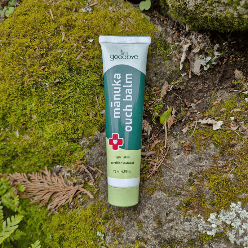 Manuka Ouch Balm tube on a natural background with moss and leaves