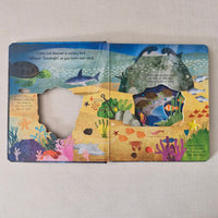 Colourful children's book with under water illustrations on a plain background