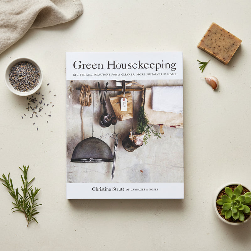 Book titled 'Green Housekeeping' by Christina Strutt, sitting on white benchtop