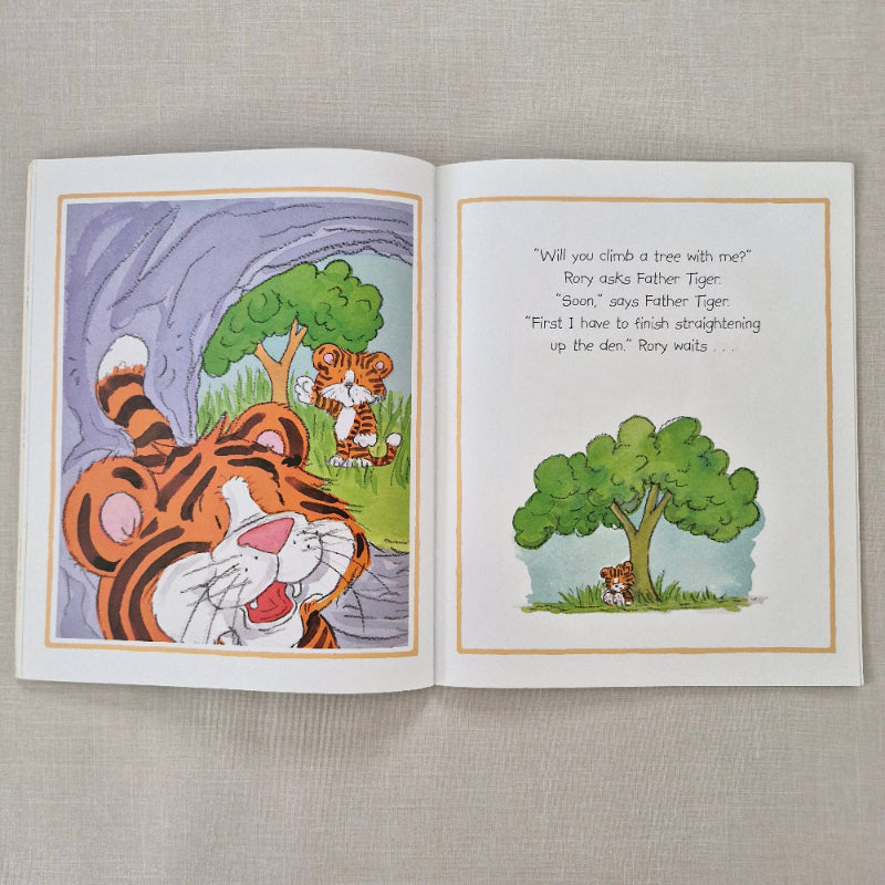 Open children's book with illustrations of tigers and text on a textured surface