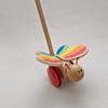 Wooden toy butterfly with rainbow wings on a white background