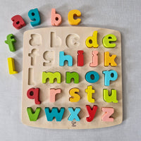 Wooden alphabet puzzle with colourful letters on a light grey background