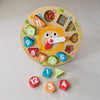 Wooden educational clock with colourful shapes and numbers on a light grey background