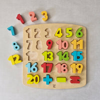 Wooden puzzle with colourful numbers on a light grey background