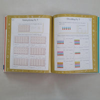 Open book with educational times tables content on a plain background