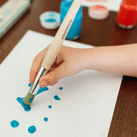 Childs hand painting with a Honeysticks jumbo paint brush