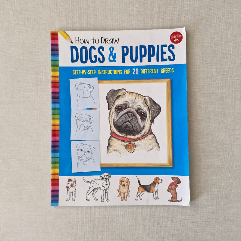 Book cover of 'How to Draw Dogs & Puppies' on a textured beige background