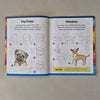Open book with illustrations of dogs on a textured surface